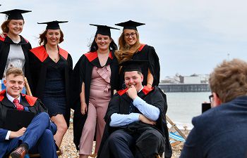 Students at Brighton beach on summer graduation 2022