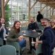 A photo of five colleagues from the School of Life Sciences around a table. Some have a cup of coffee or tea in their hands