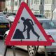 A triangular roadworks sign