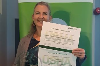 Katie Bennett with the team's award and two certificates