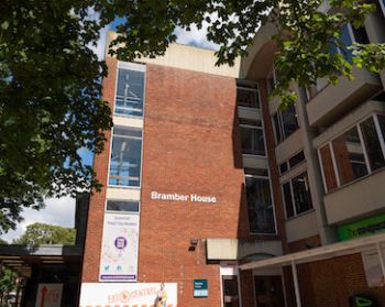 red brick building with a sign reading Bramber House