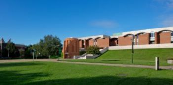 An image showing the proposed new Library entrance including a new brick tower containing a lift and a new ramp along the top of the Library's grassy bank